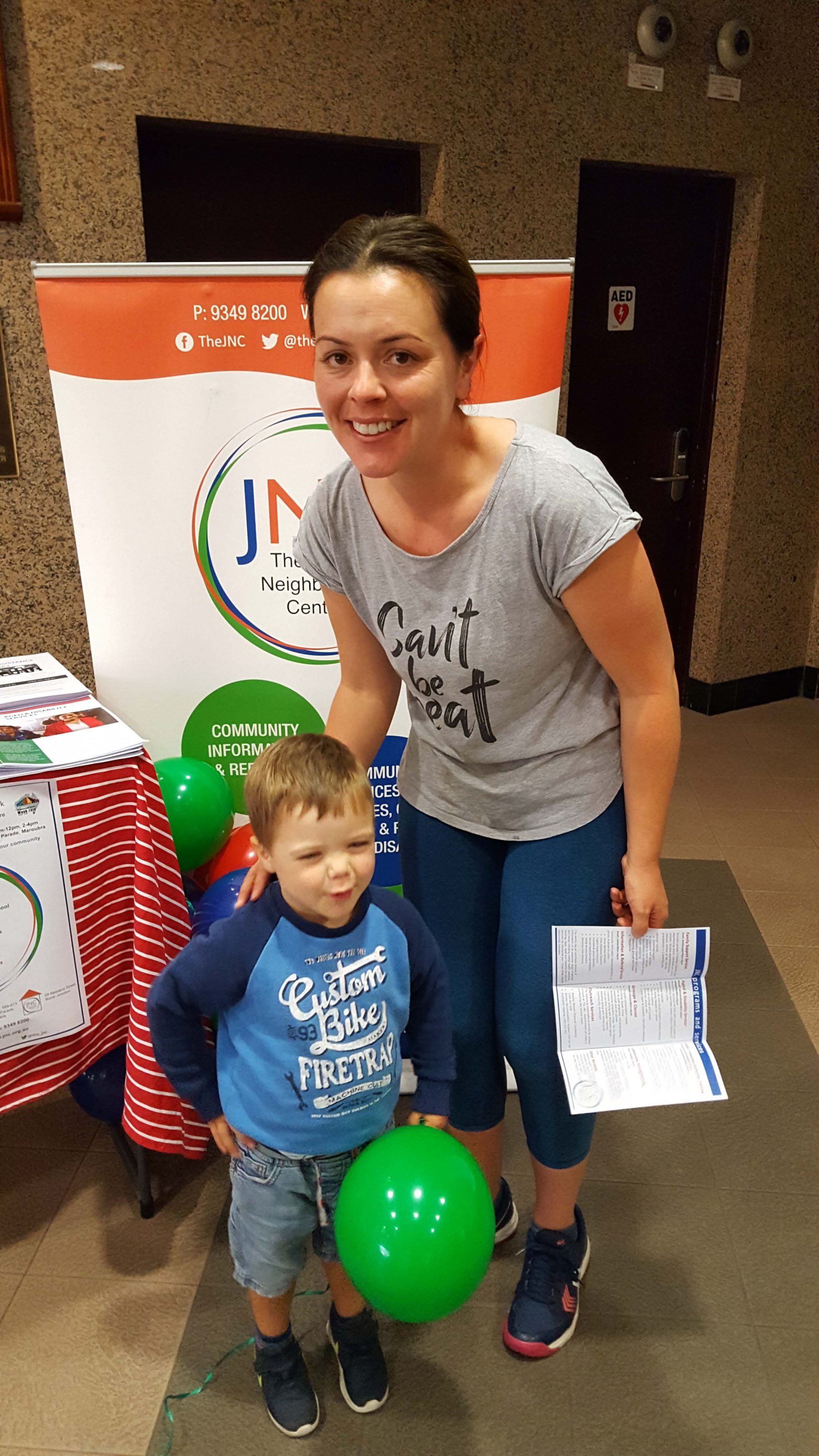 photo of mother and young son at The JNC's Neighbourhood Centre week display