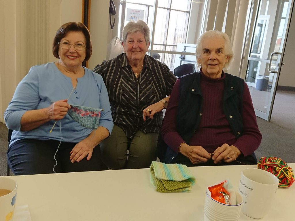 Three people at knitting group for older people run by The JNC