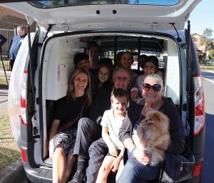 group of people all ages plus dog inn The JNC Community Linker Van