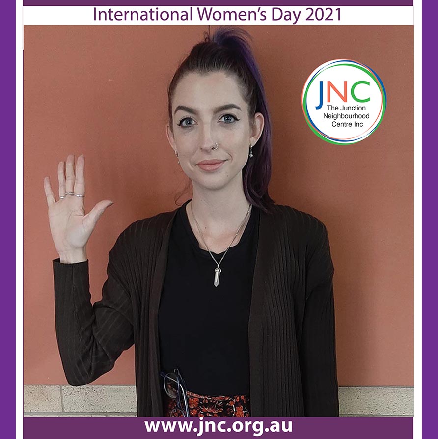 poster with woman with raised hand and the words International Women's Day 2021